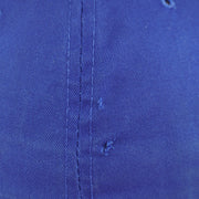 Close view of a small tear in the royal blue crown of the Pistons cap