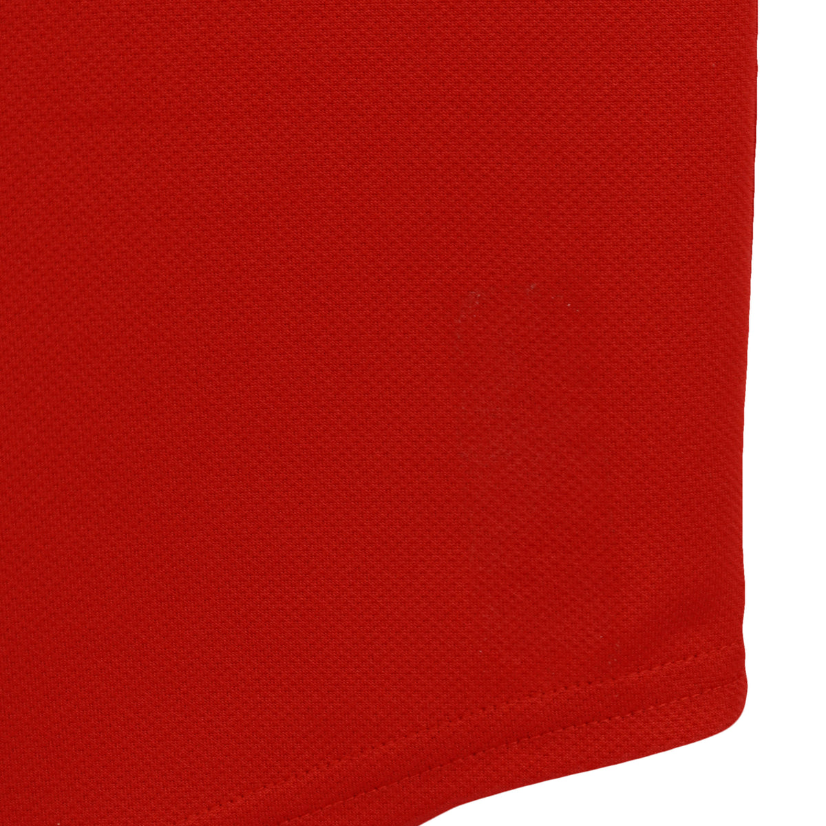 Small mark on the red jersey fabric near the hem