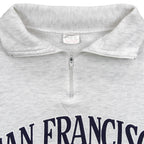 Close-up of the faded neck label and gray quarter-zip collar construction