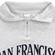 Close-up of the faded neck label and gray quarter-zip collar construction