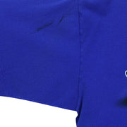 Close-up of a dark mark beside the side seam on the blue Lightning T-shirt