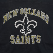 Close-up of the New Orleans Saints wordmark and fleur-de-lis print on the black 1990s V-neck T-shirt.