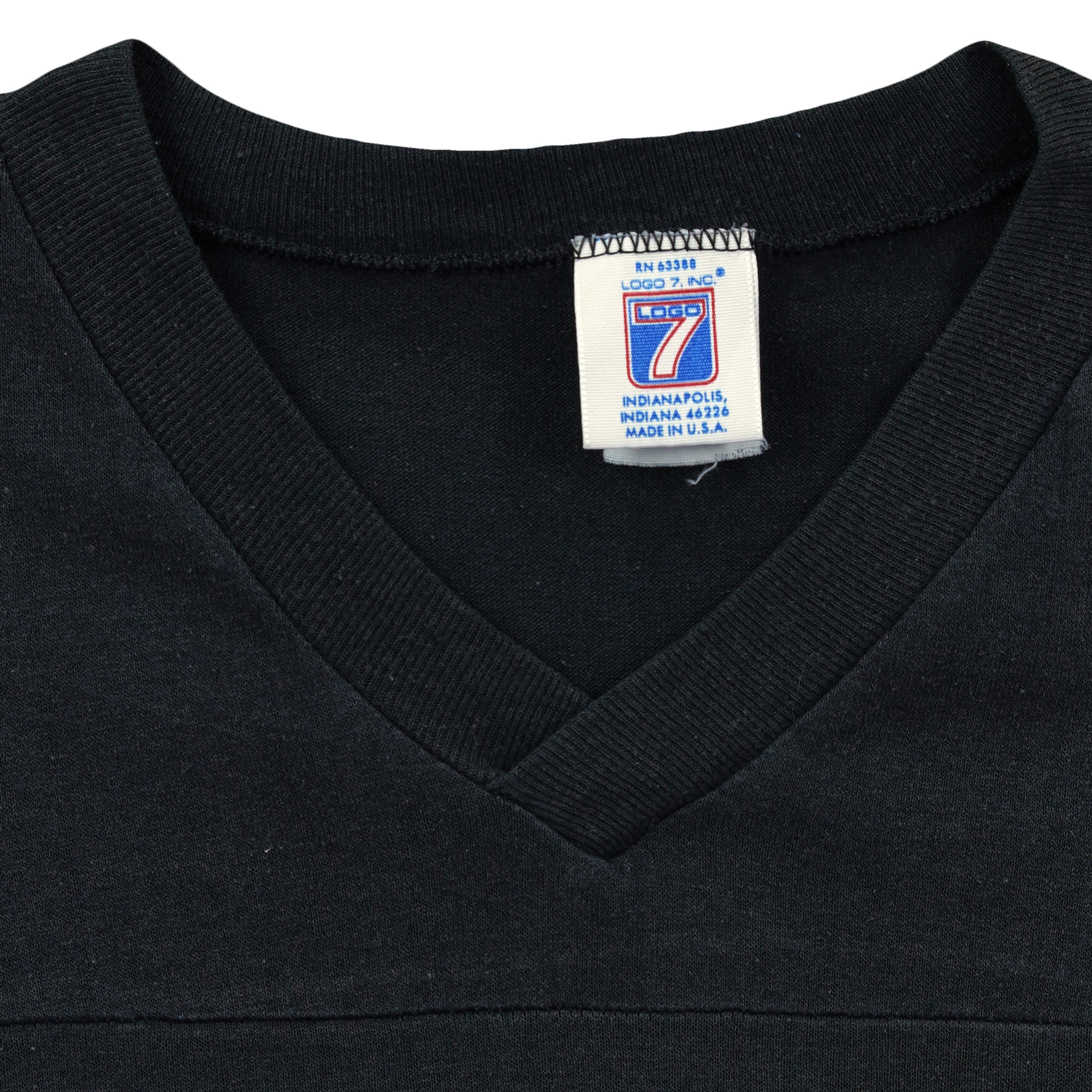 Close-up of the Logo 7 neck label with no readable size inside the black and white 1990s T-shirt.