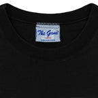 Close-up of the The Game neck label showing size L inside the black 1995 T-shirt.