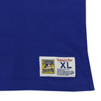 Close-up of the Mitchell & Ness Cooperstown Collection hem patch on the blue mesh Blue Jays tank top.