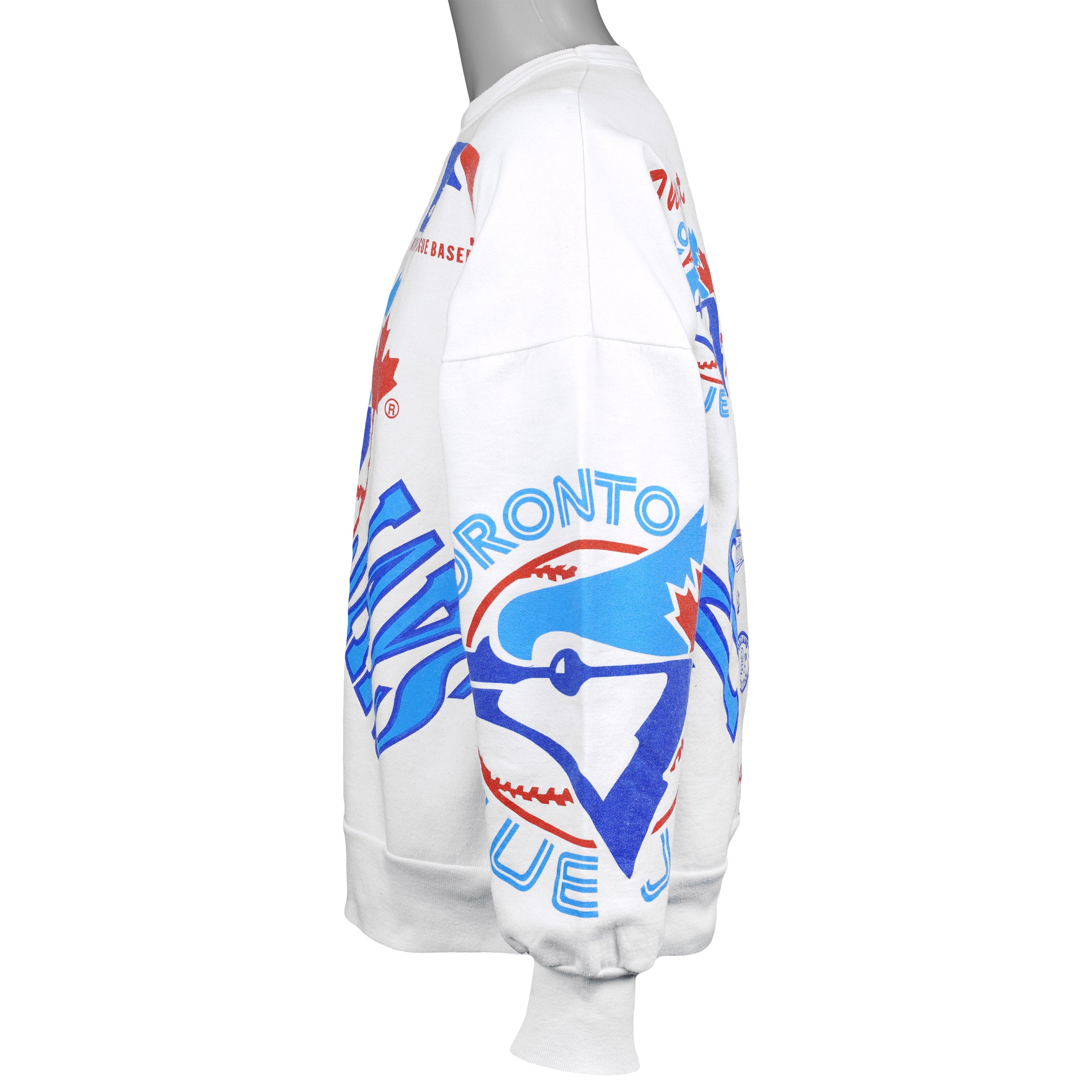 Right-side view of the white Blue Jays sweatshirt showing the all-over team print across the sleeve and body.