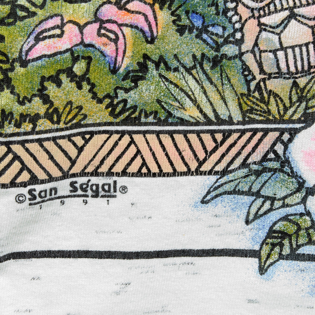 Close view of tropical flowers, the printed border, and San Segal 1991 copyright.