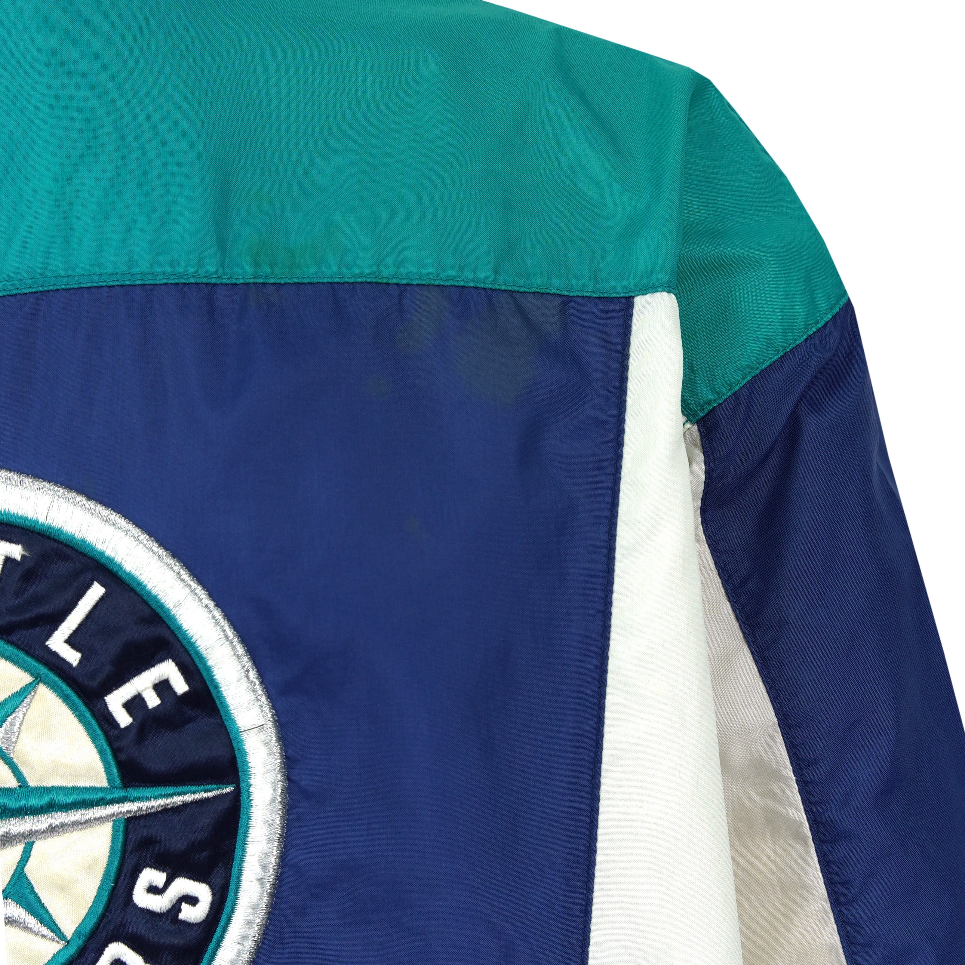Close view of a minor mark on the teal shoulder panel of the Mariners jacket
