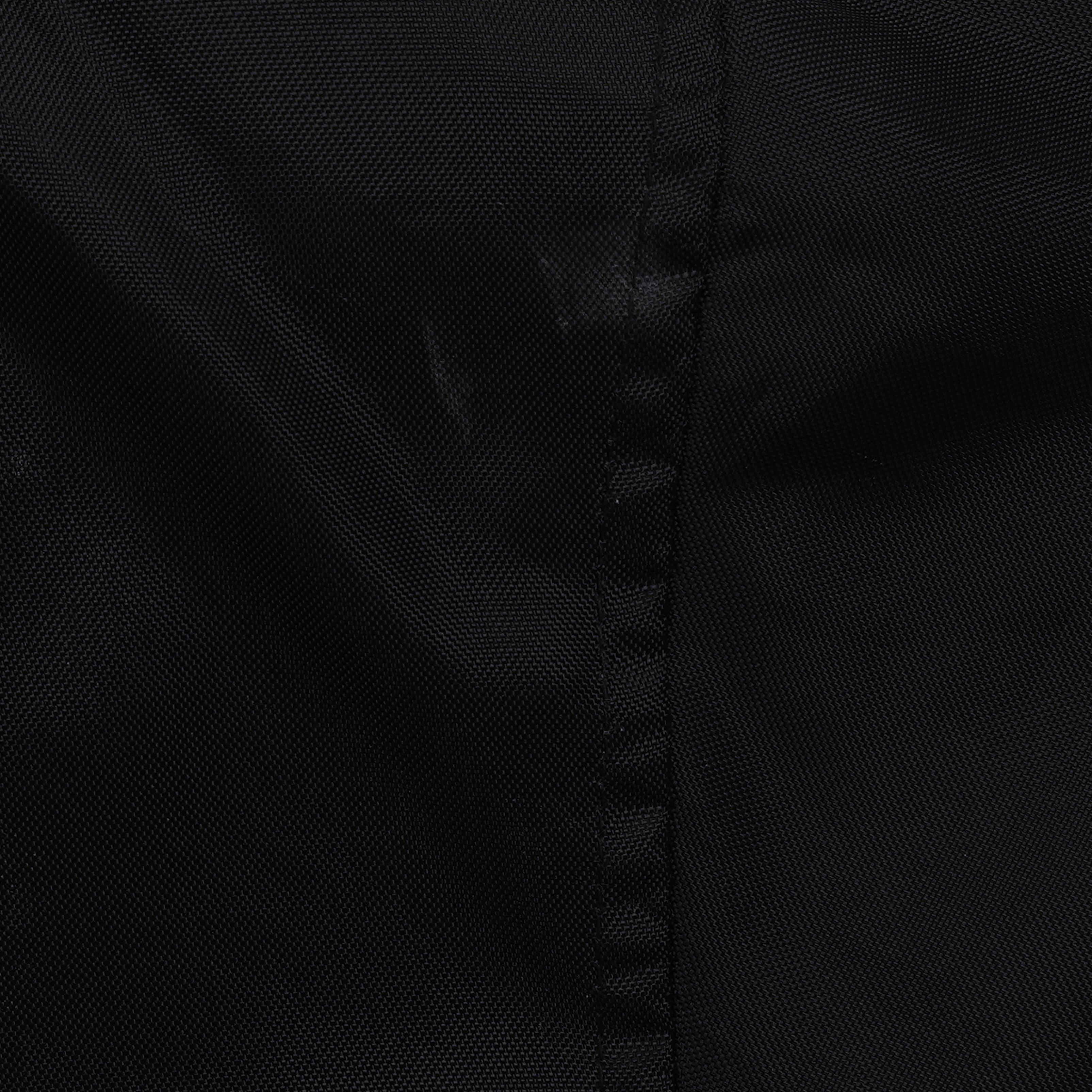 Close view of a small worn area beside a seam on the black White Sox jacket