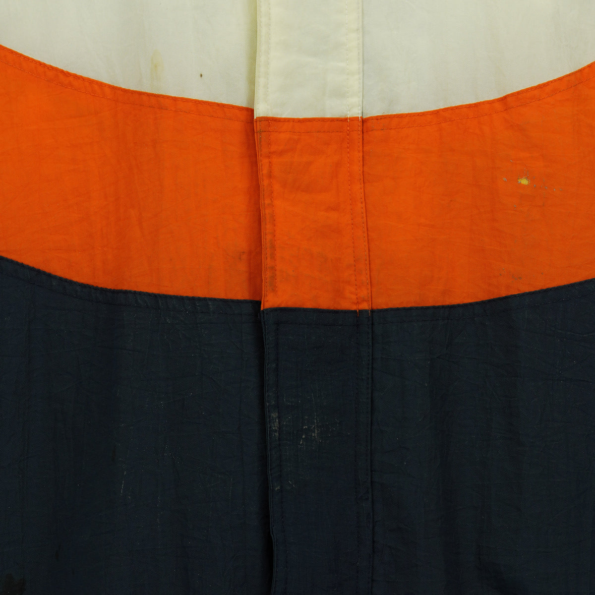 Close-up of marks and repaired wear on the jacket front.