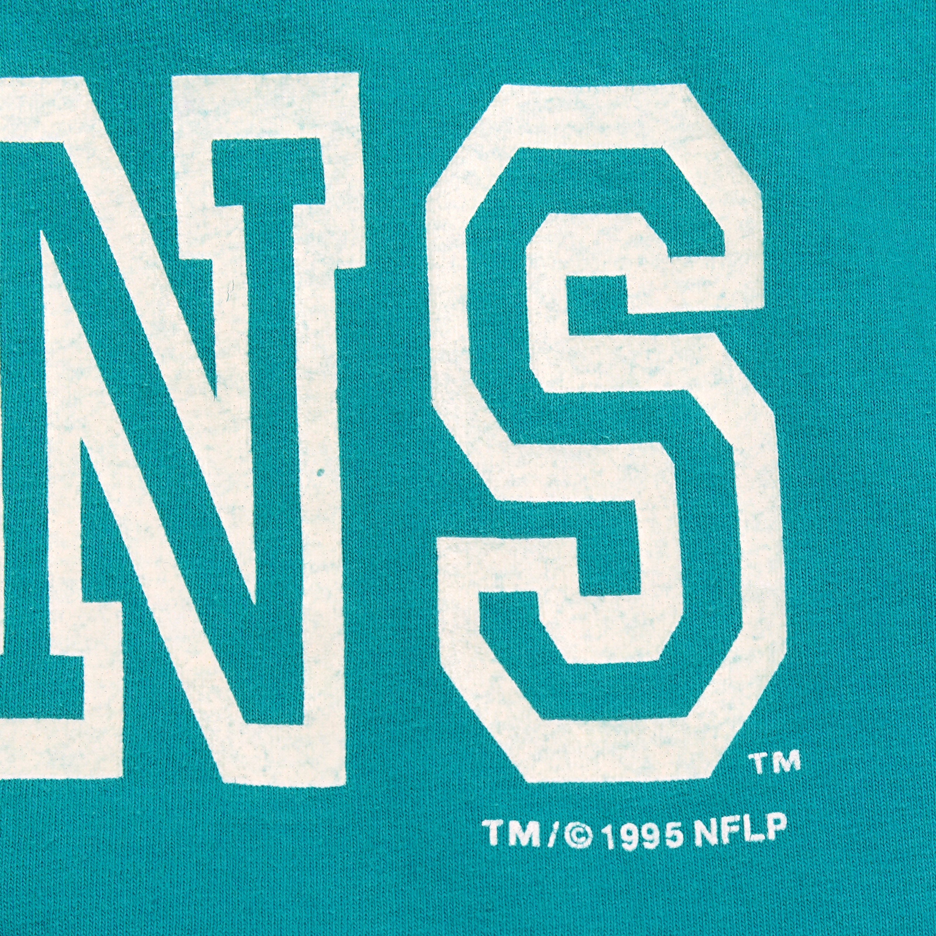 Close-up of the Miami Dolphins print and 1995 NFL copyright text