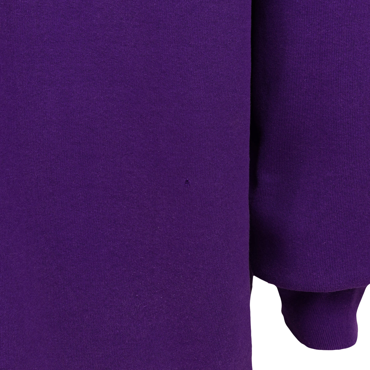 Close-up of a faded area on the purple sweatshirt sleeve