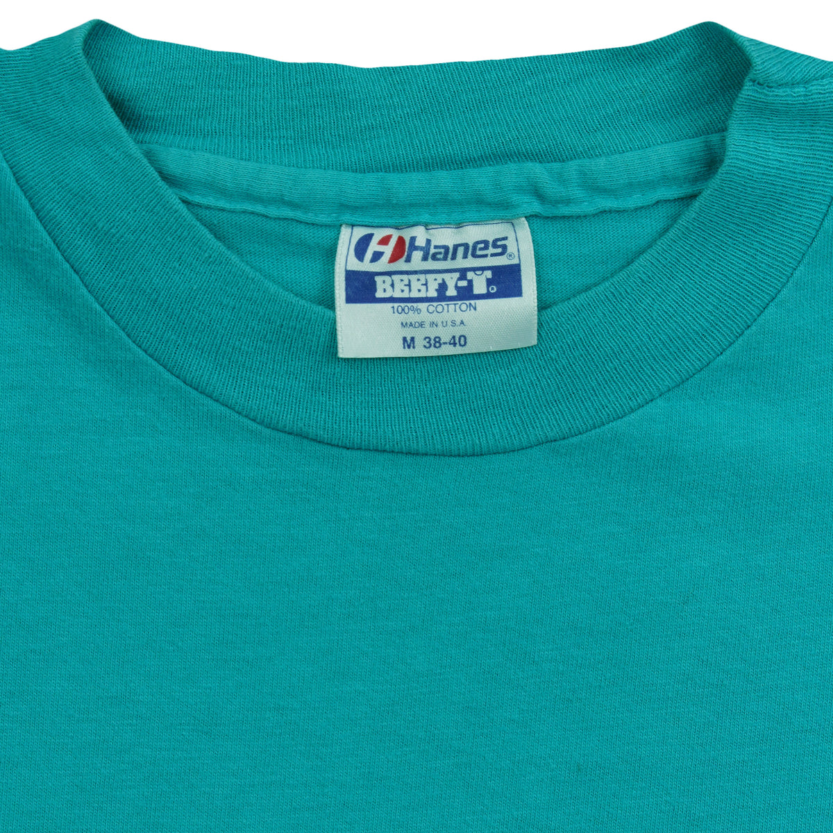 Hanes Beefy-T Medium label inside the turquoise Bruins T-shirt