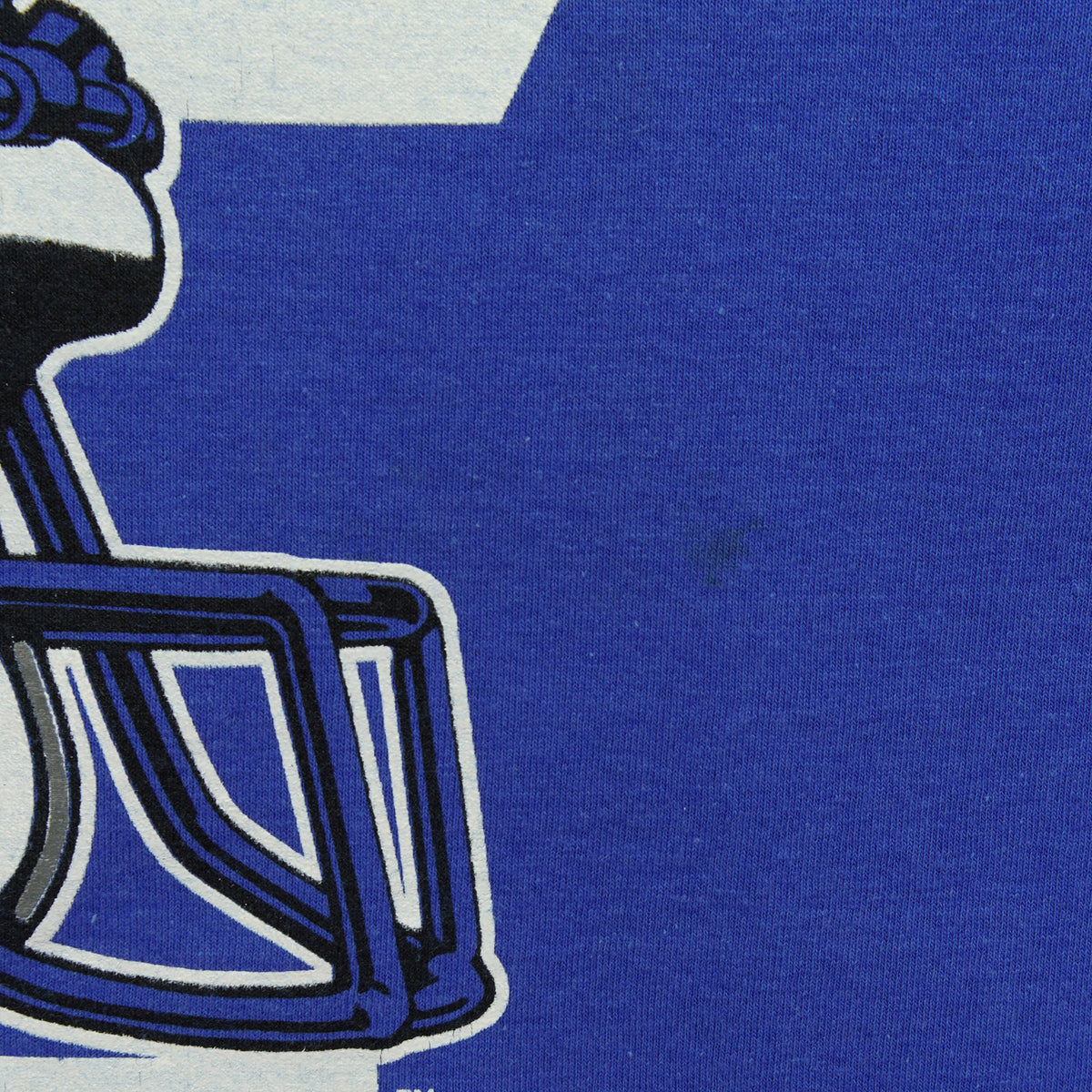 Detail of a minor mark beside the faded helmet print on blue fabric