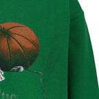 Close-up of the cracked basketball and Celtics team-history print