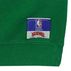 Official NBA Nutmeg patch sewn near the green sweatshirt hem