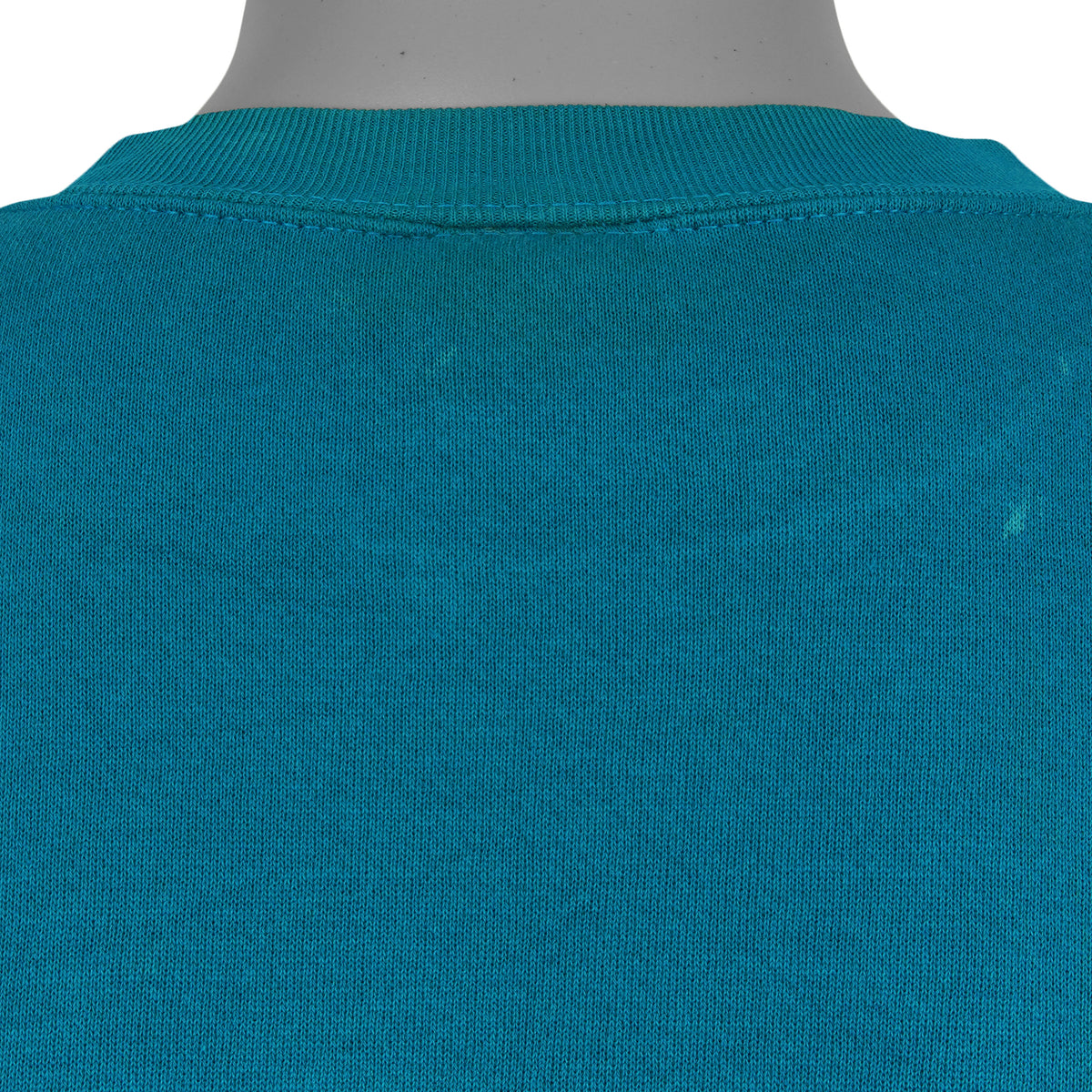Close view of the repaired upper-back area and small fabric mark