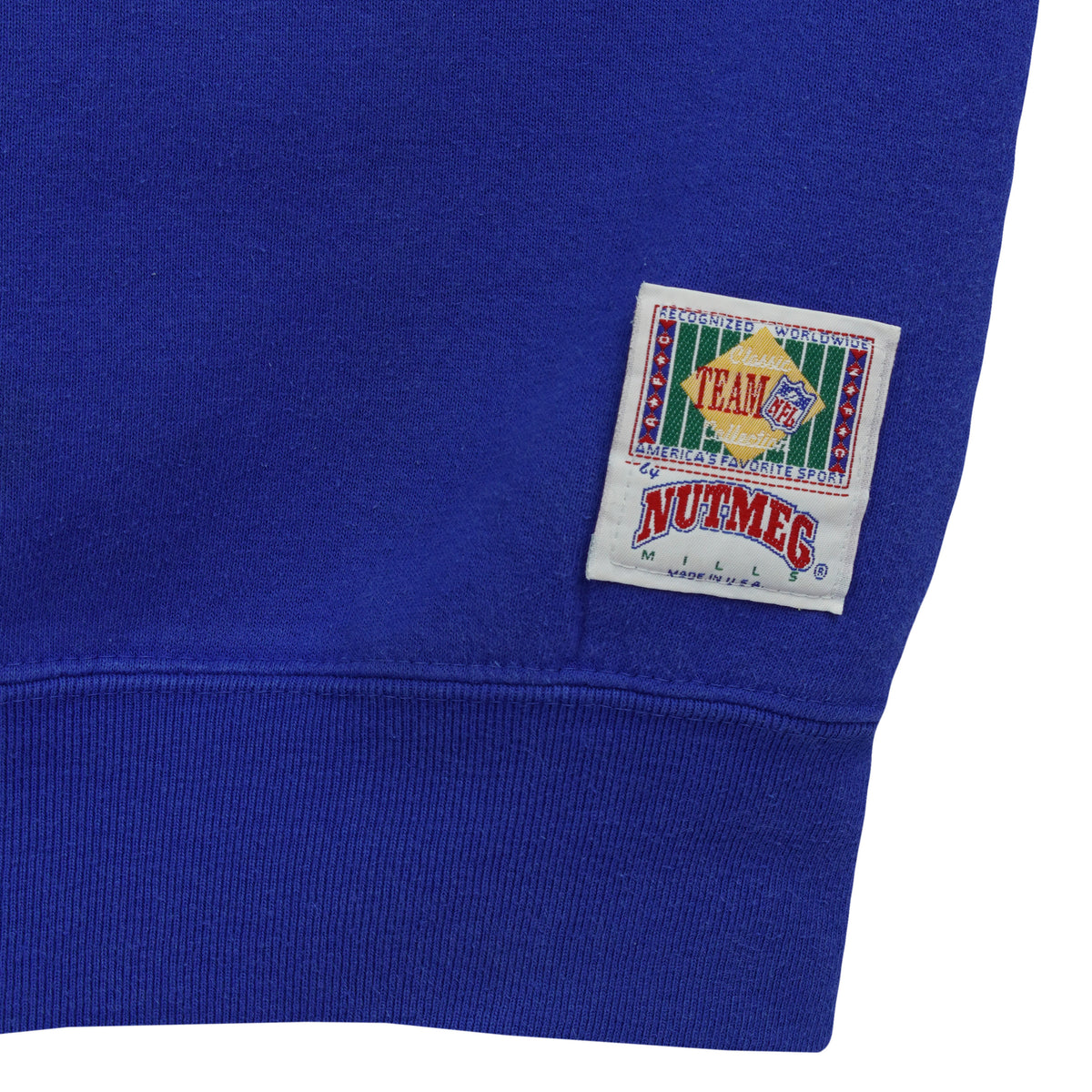Nutmeg hem patch and minor sleeve marks on the blue sweatshirt