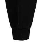 Close view of a minor mark near the black sweatshirt cuff