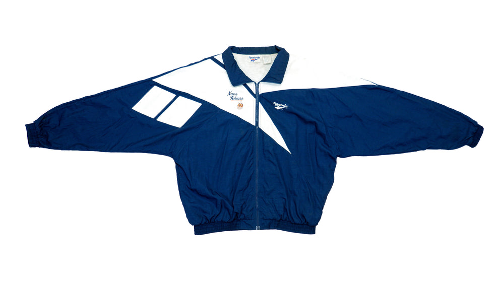 Reebok - Blue News Release Windbreaker 1990s X-Large Vintage Retro 